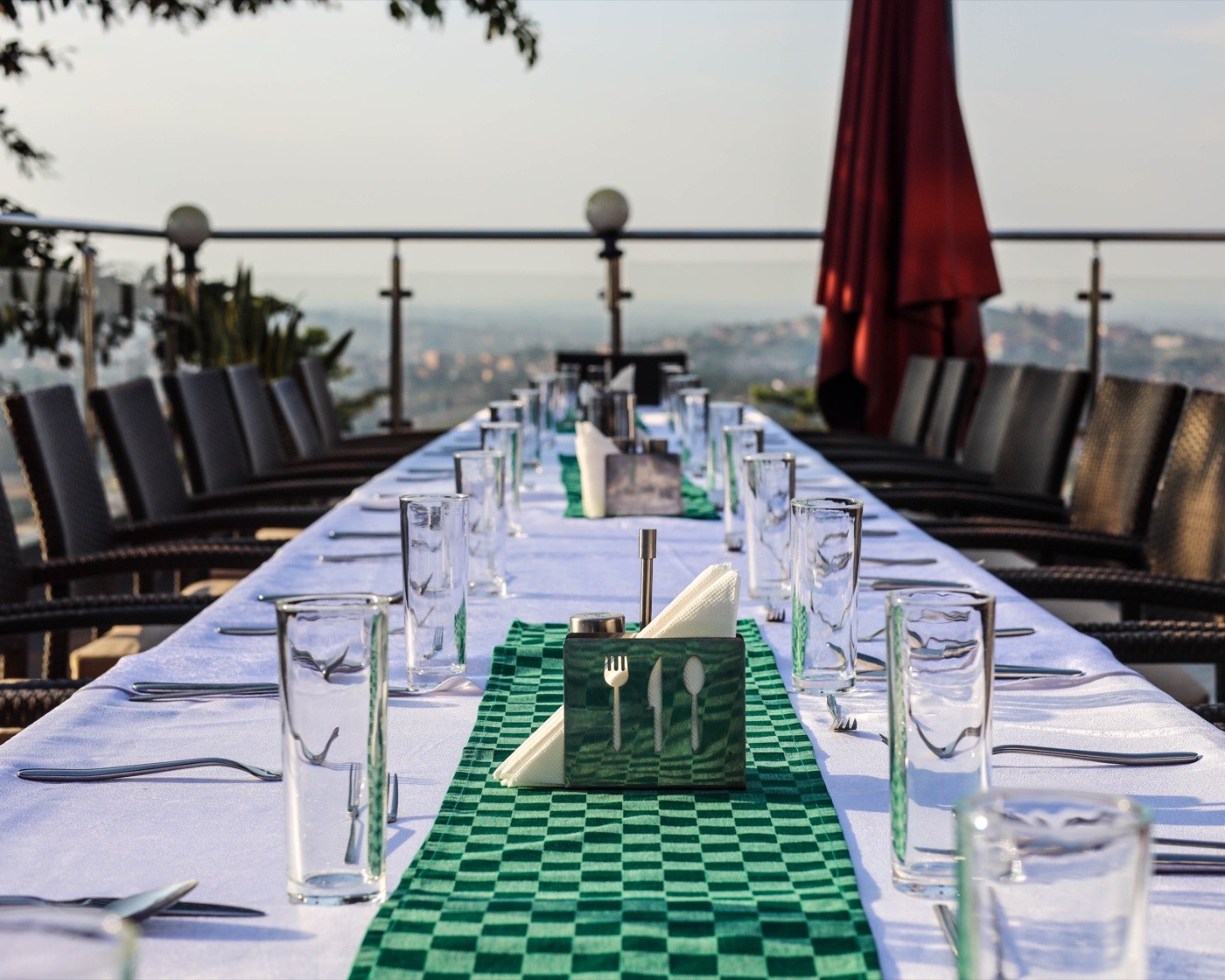 A table set on Aruba Terrace for a daytime gathering with sweeping views over Kampala