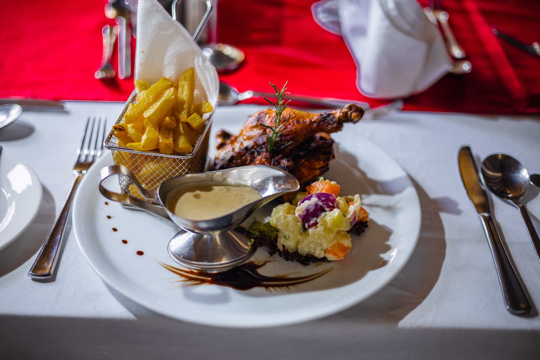 Grilled chicken quarter with a basket of fries at Chapter Two Restaurant