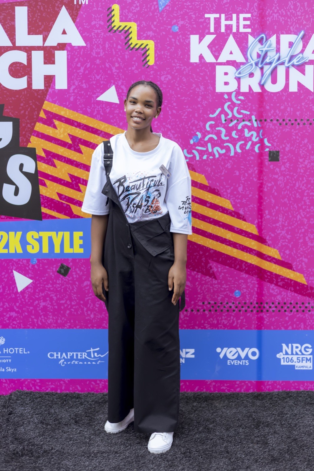 A guest poses at The Kampala Style Brunch, 90's Throwback and Y2K style backdrop, August 2024