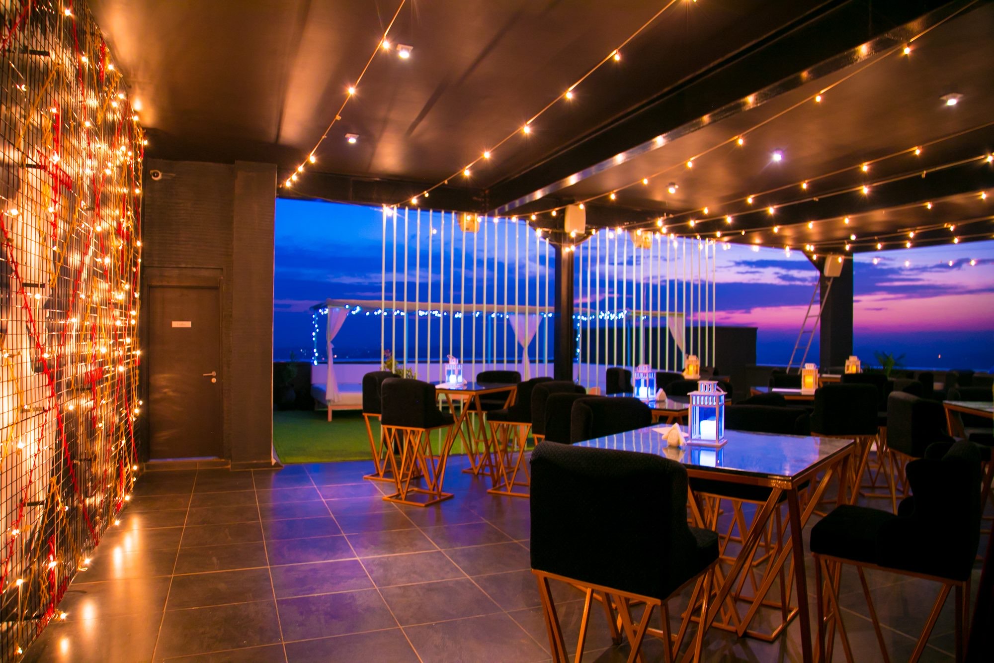 Ninety9 Rooftop at night with city views