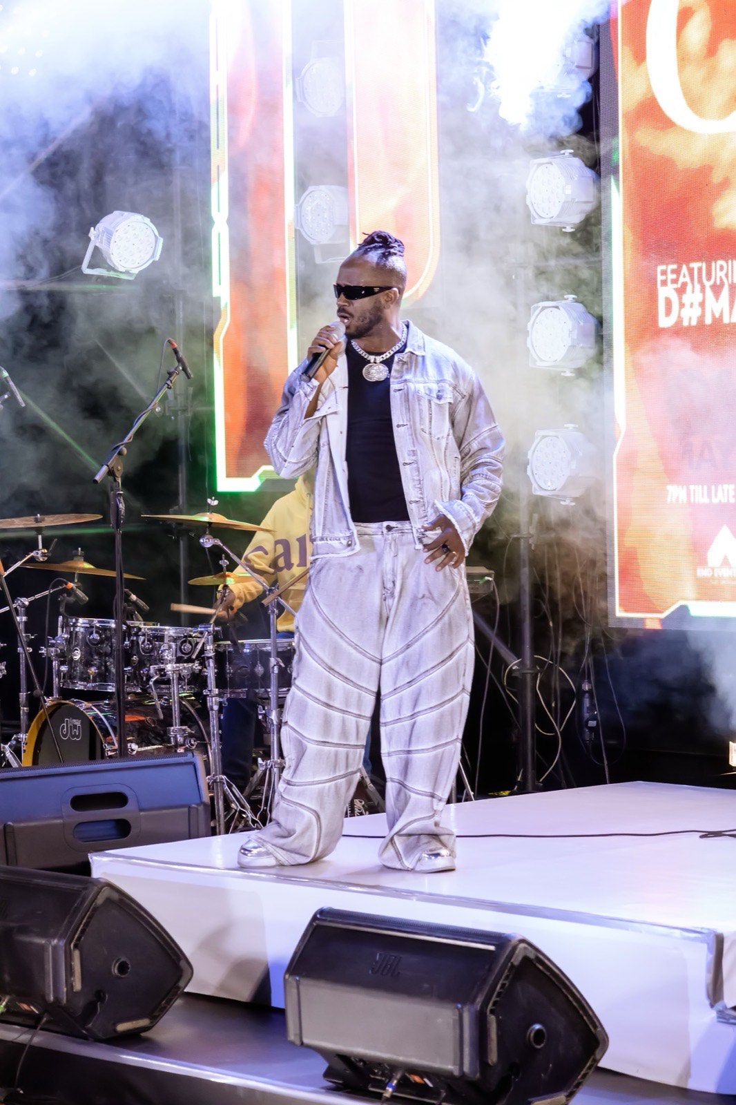 Bebe Cool performing with D'Maestroz Band billed on the screen behind him