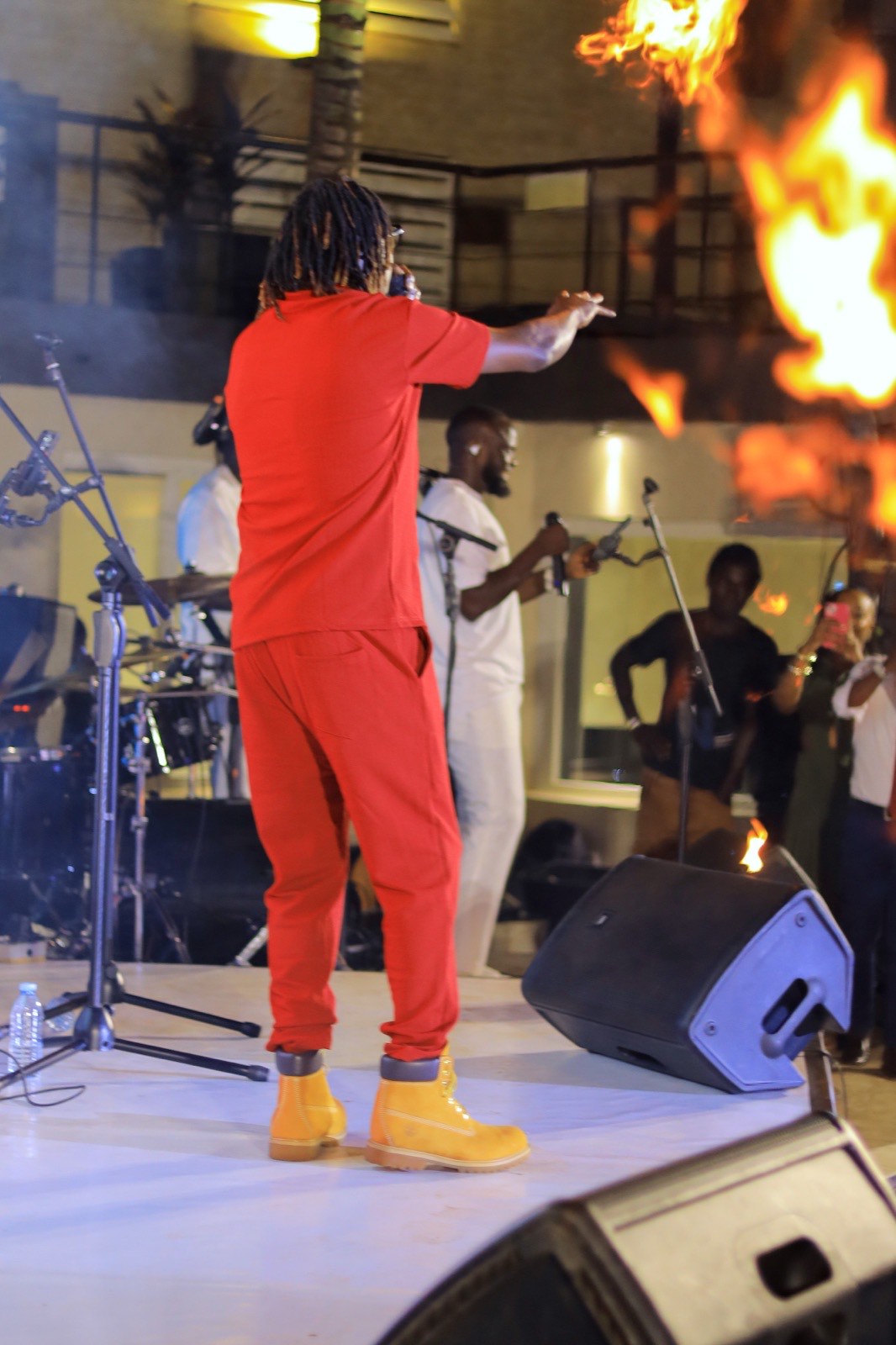 King Saha on stage with a pyrotechnic flame effect at The Skyz Exclusive