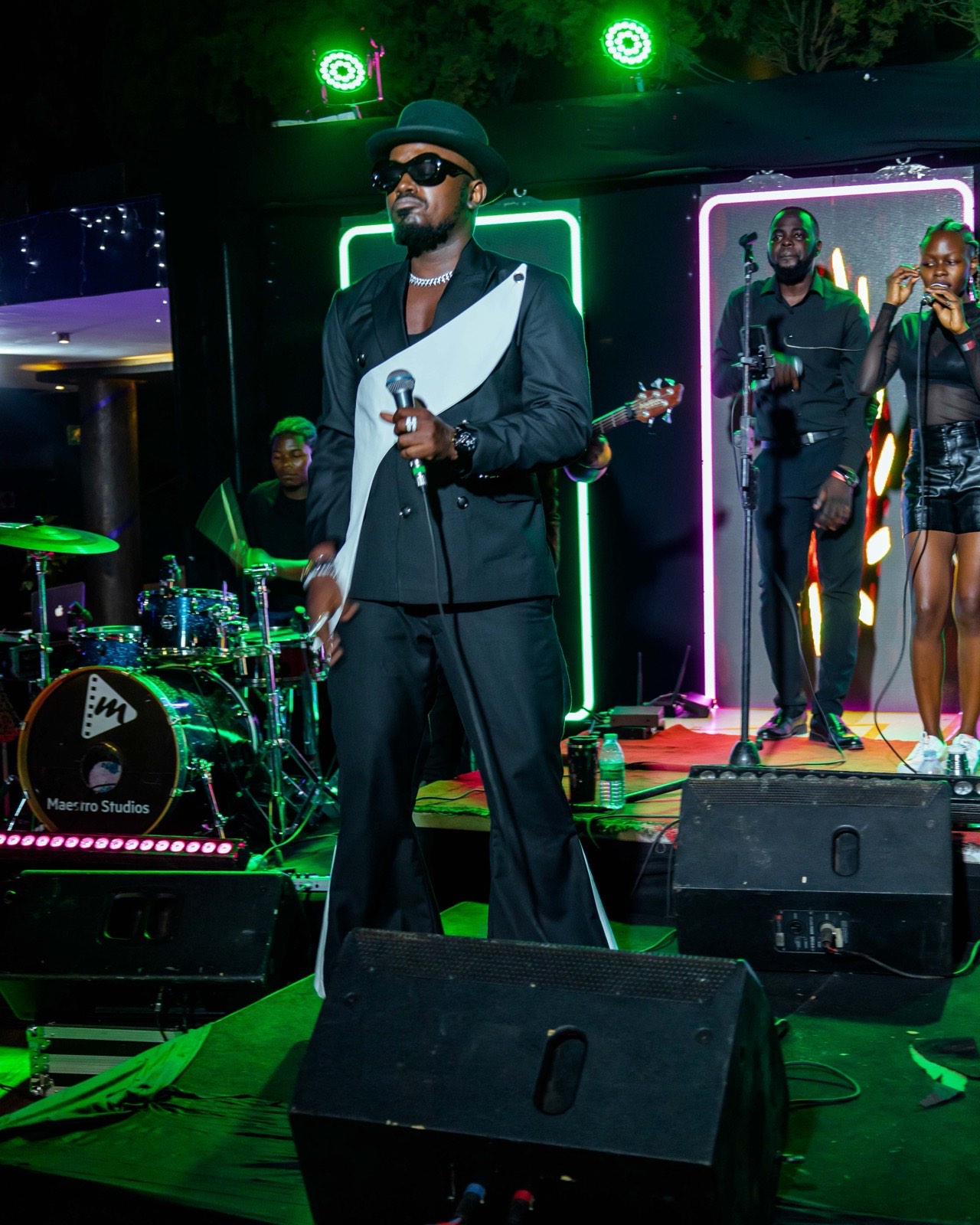Ykee Benda singing on stage at Tropicanna Poolside