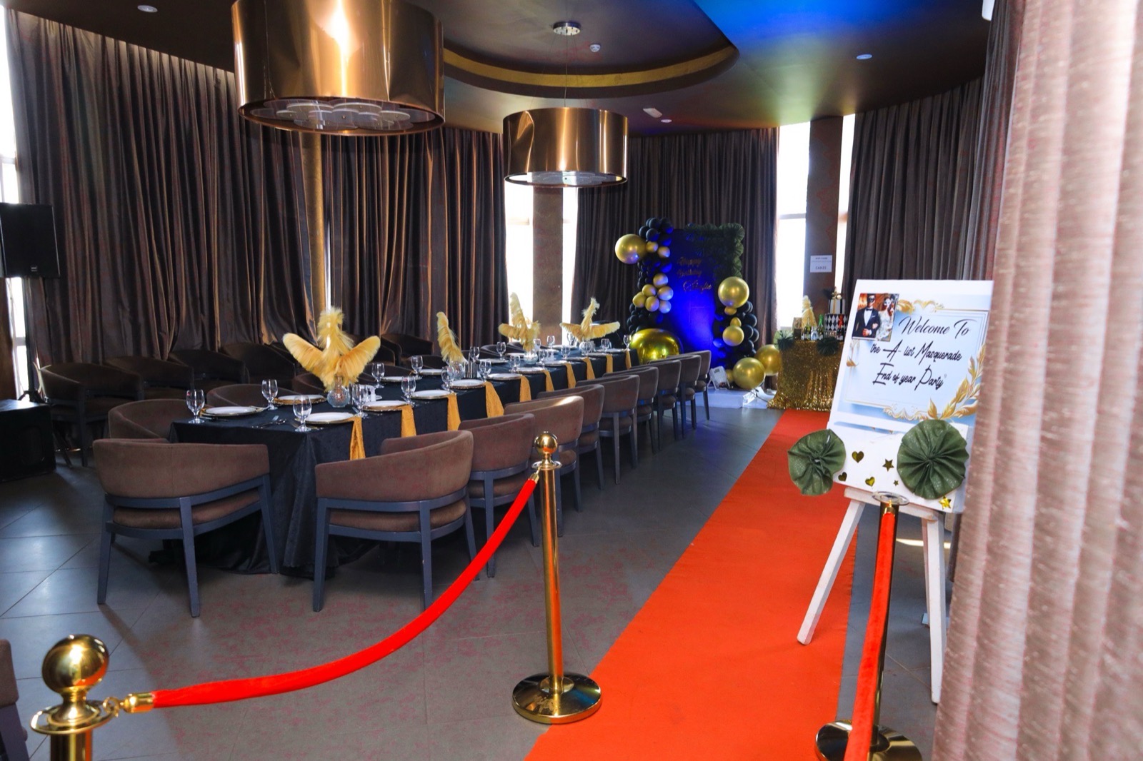 Red carpet arrival into the VIP Room at Skyz Hotel Kampala, styled with black-and-gold table settings and pendant lighting for an evening private party